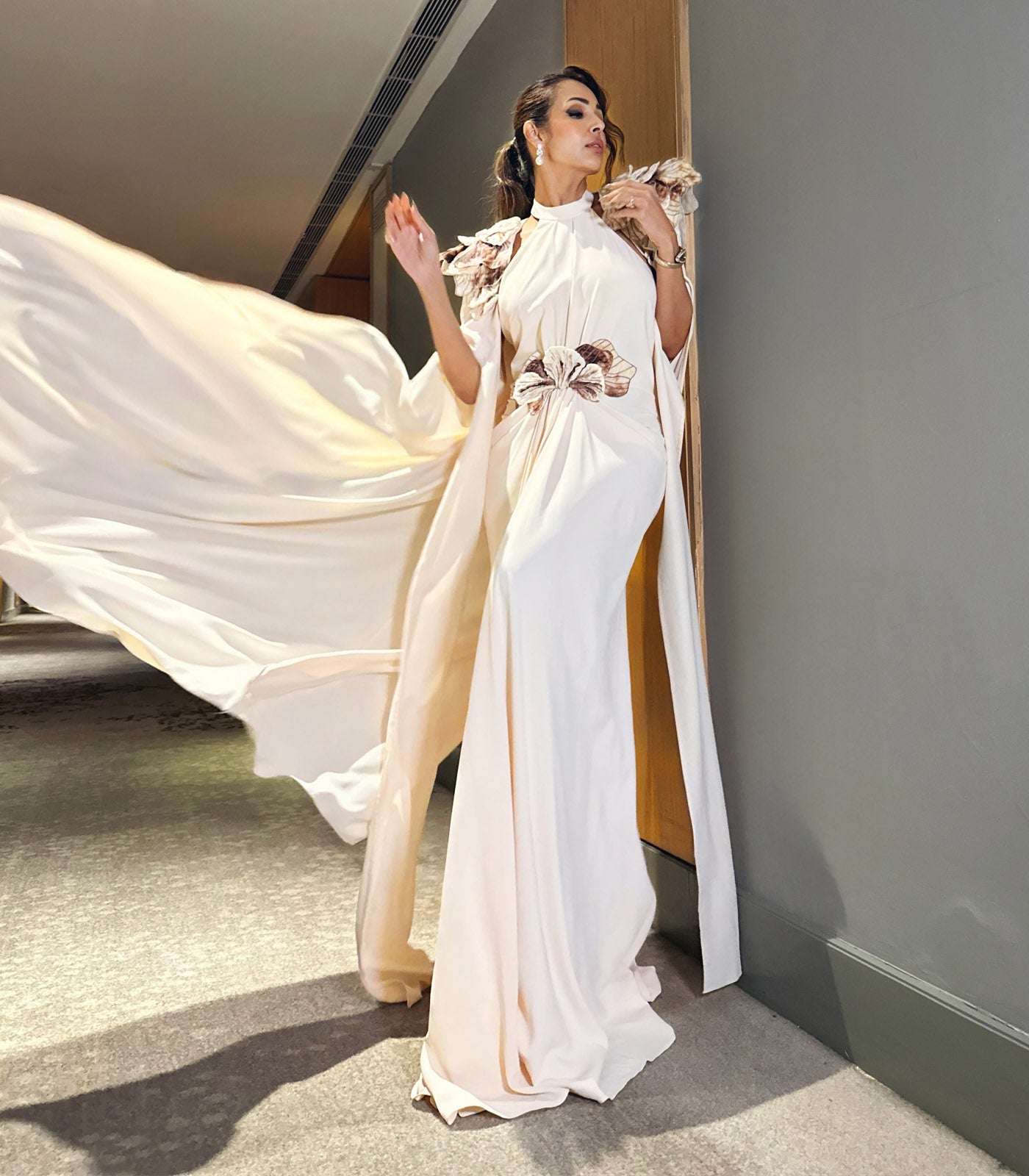 Malaika Arora spotted in our off white drape sleeve gown with cape